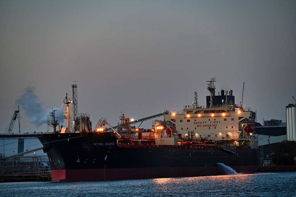 a large cargo ship in a harbor at night