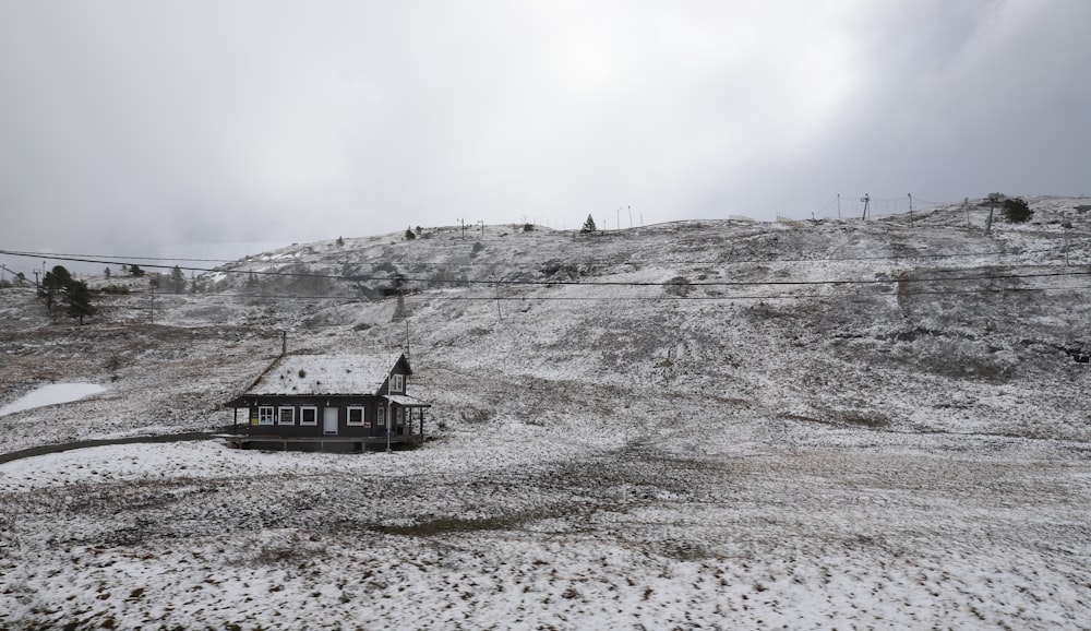 a house on a hill covered in snow