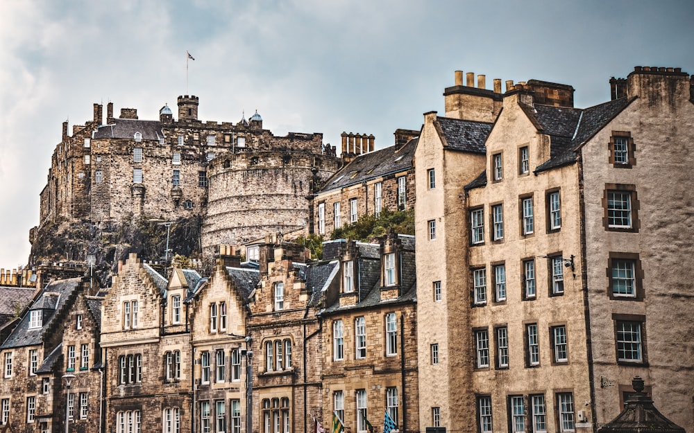 a group of buildings with a castle in the background