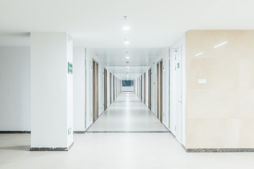 a long hallway with white walls and doors