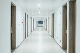 a long hallway with doors leading to another room