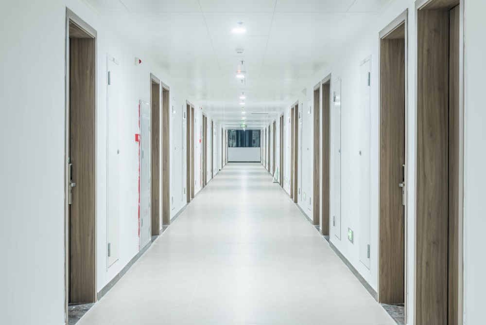 a long hallway with doors leading to another room