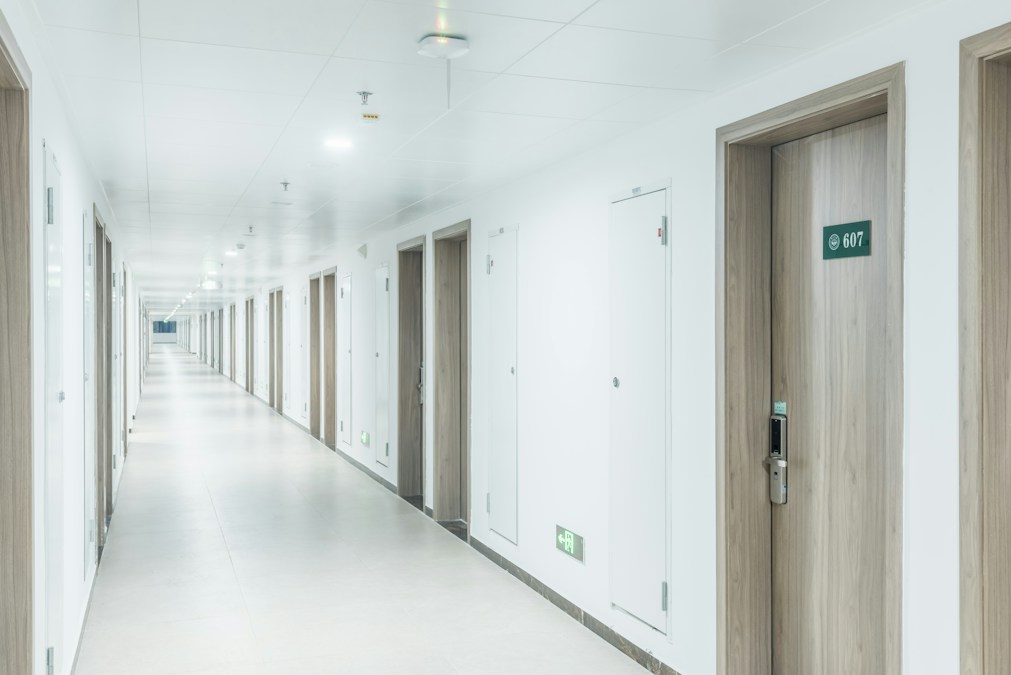 Long hallway with multiple doors in a university residence hall representing Baylor on-campus housing