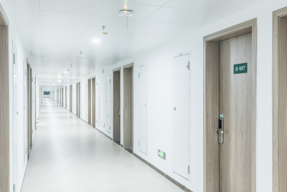 a long hallway with doors leading to another room