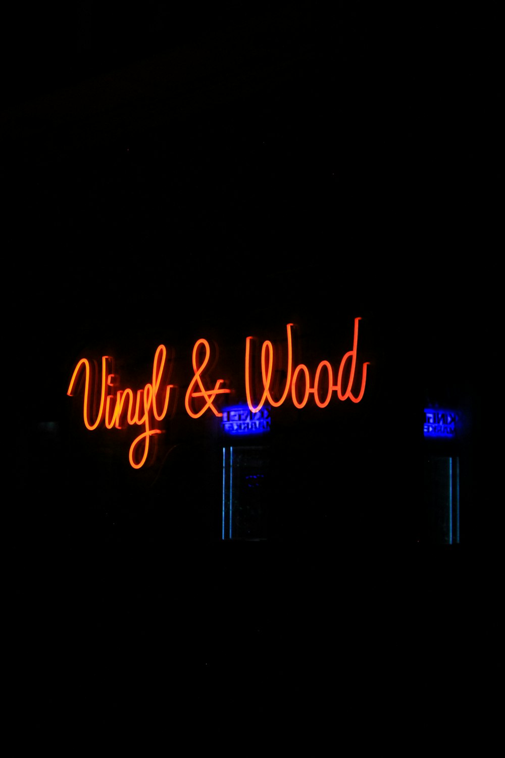 a neon sign in the dark with a dark background
