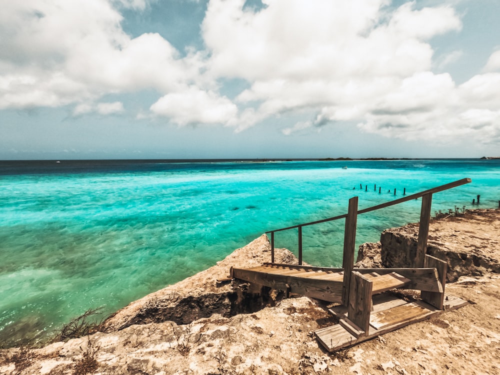 a stairway leading down to the ocean on a sunny day