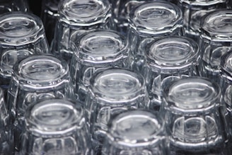 a close up of many clear glass jars