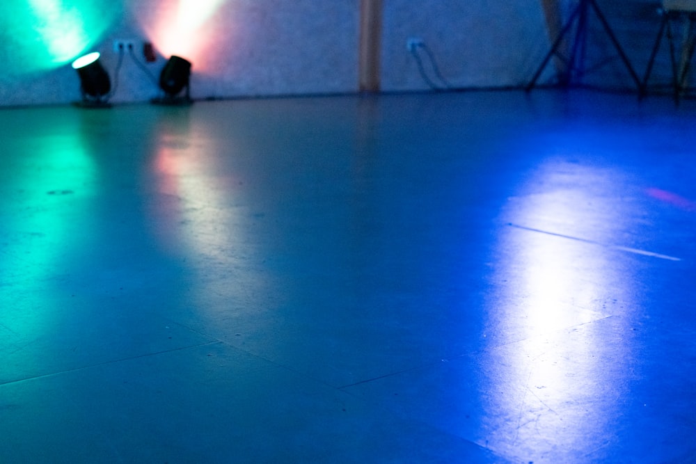 a blue and green light shines on the floor