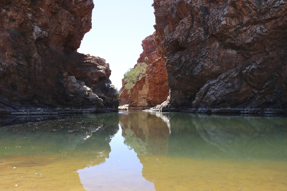 a body of water surrounded by large rocks