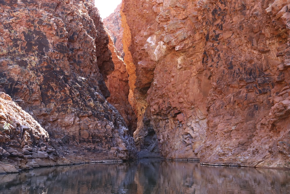 a body of water surrounded by rocky cliffs