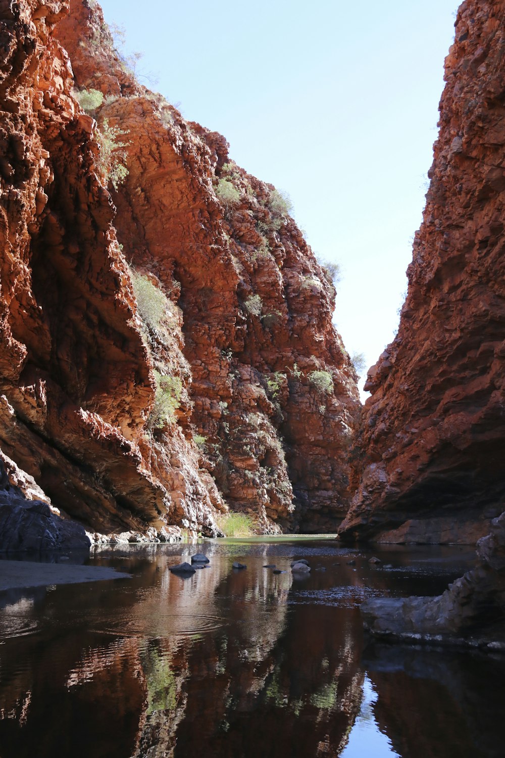 a small boat floating through a canyon filled with water