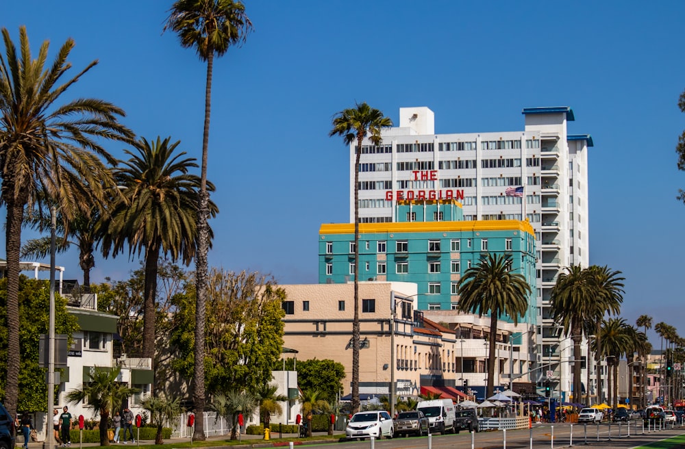 a city street lined with palm trees and tall buildings