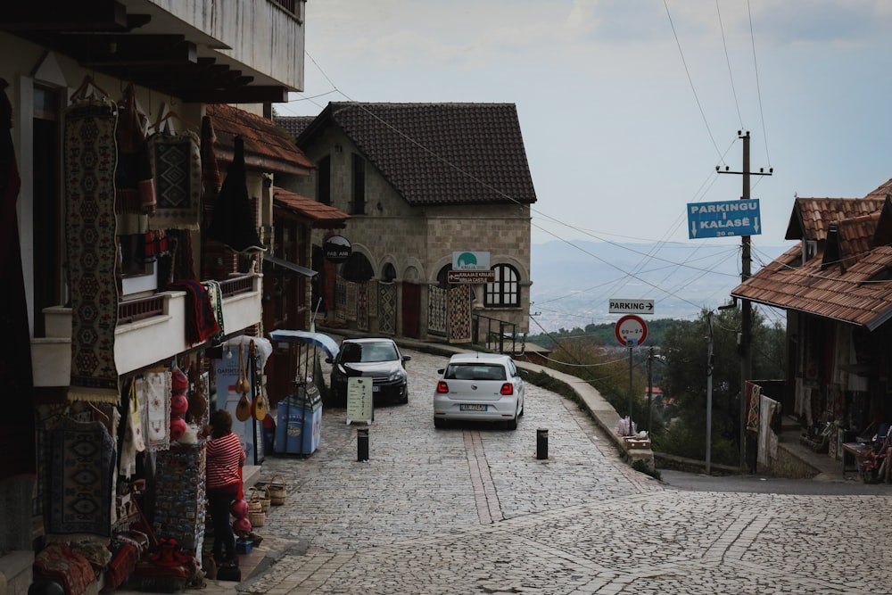 a car is parked on a cobblestone street