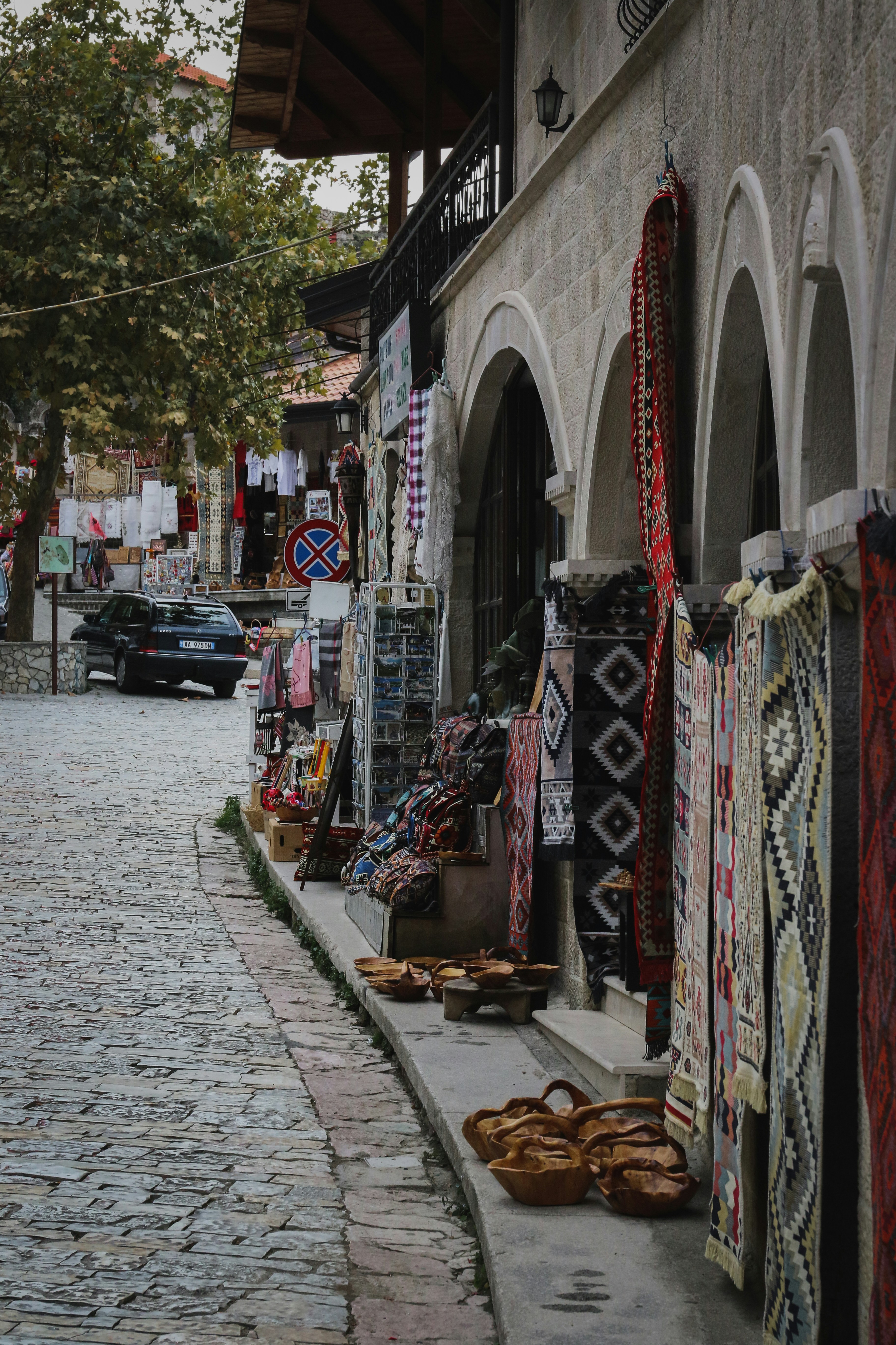 a cobblestone street lined with shops and shops