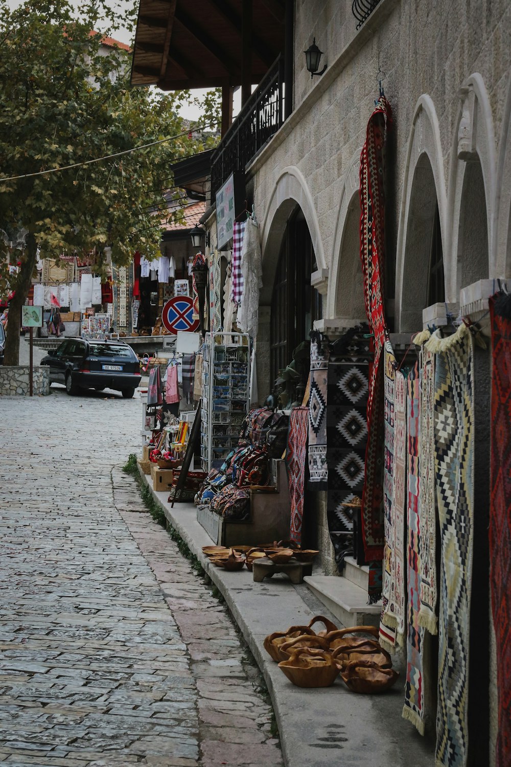 a cobblestone street lined with shops and shops