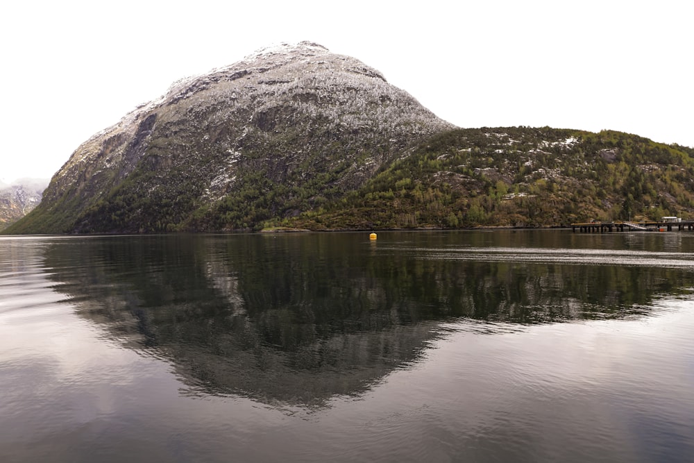 a body of water with a mountain in the background