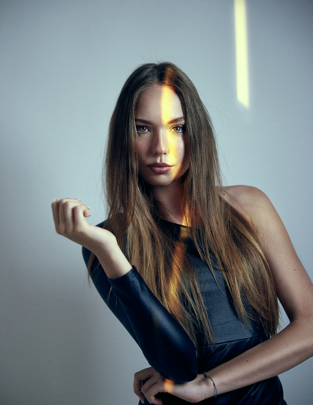 a woman with long brown hair is posing for a picture