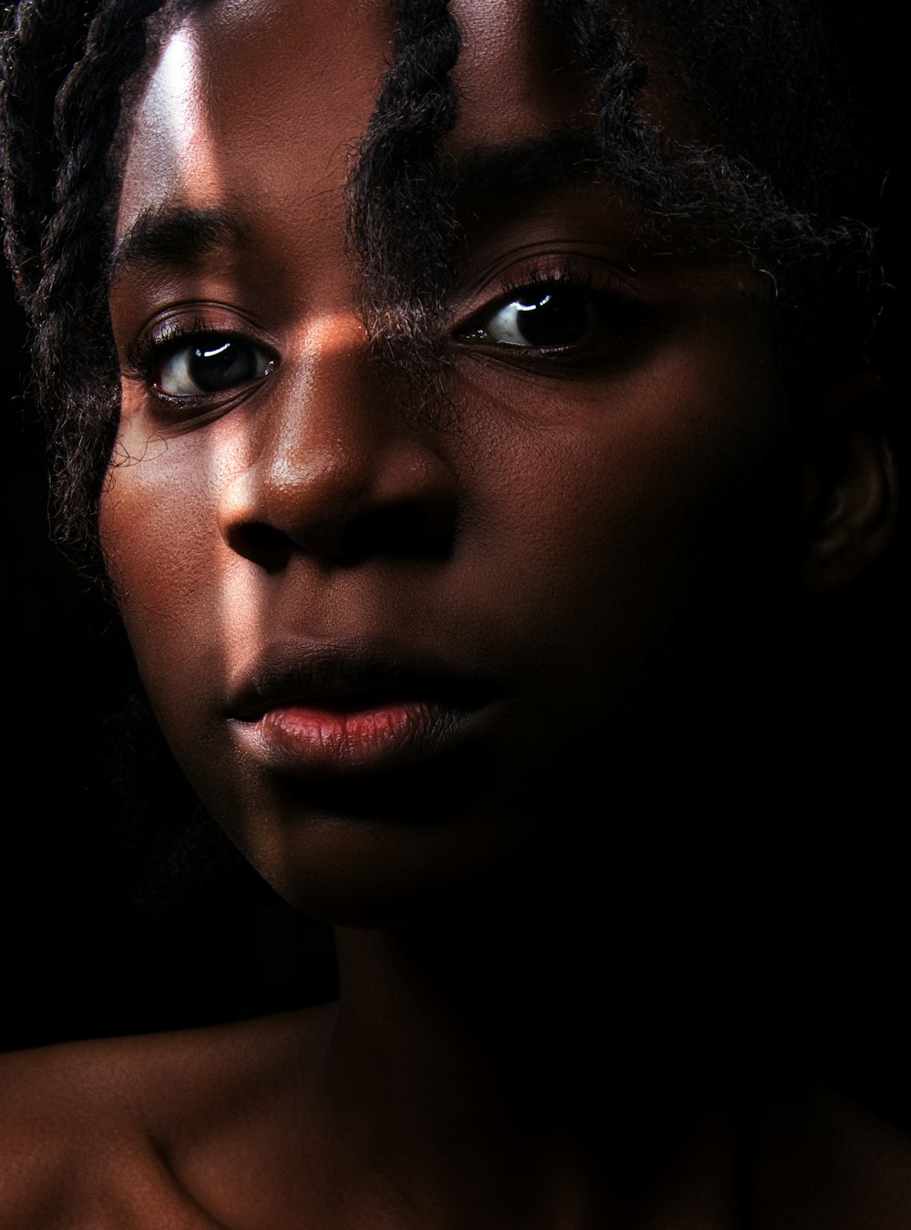 a close up of a person with dreadlocks