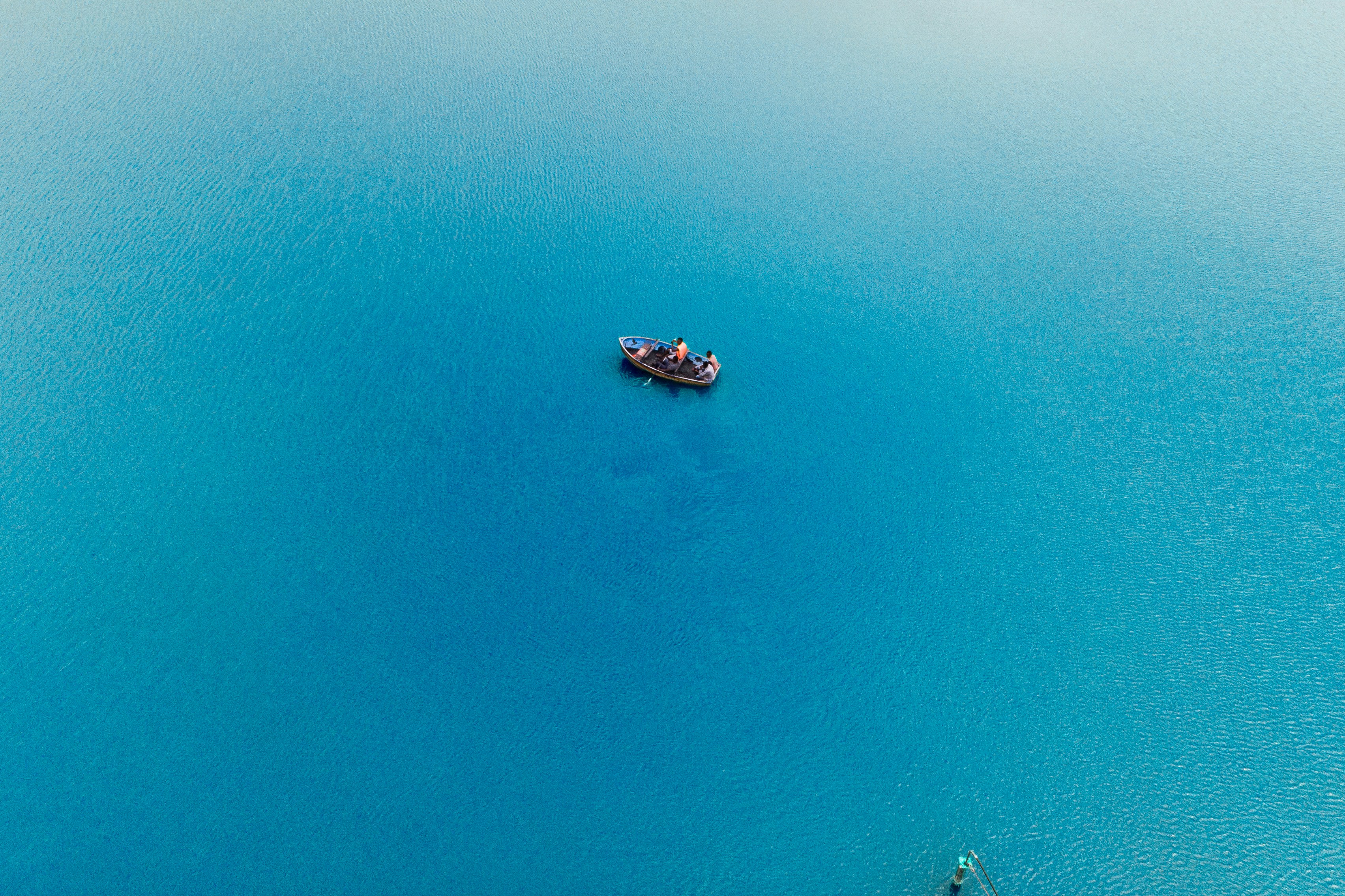 a small boat floating on top of a large body of water, Lake Duluti In Arush.