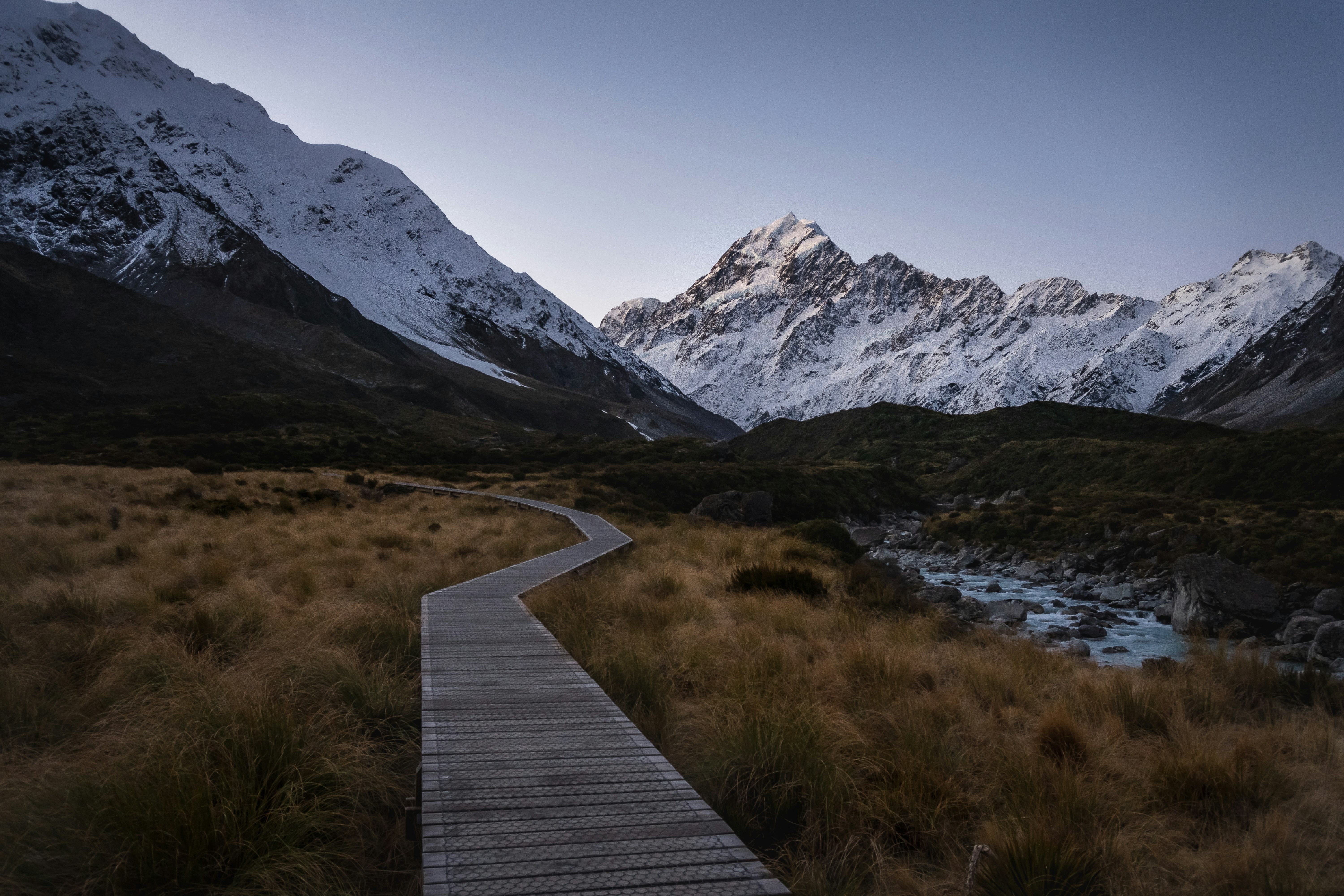 a wooden walkway leading to a mountain lake, Mount Cook from the Hooker Valley Track, New Zealand