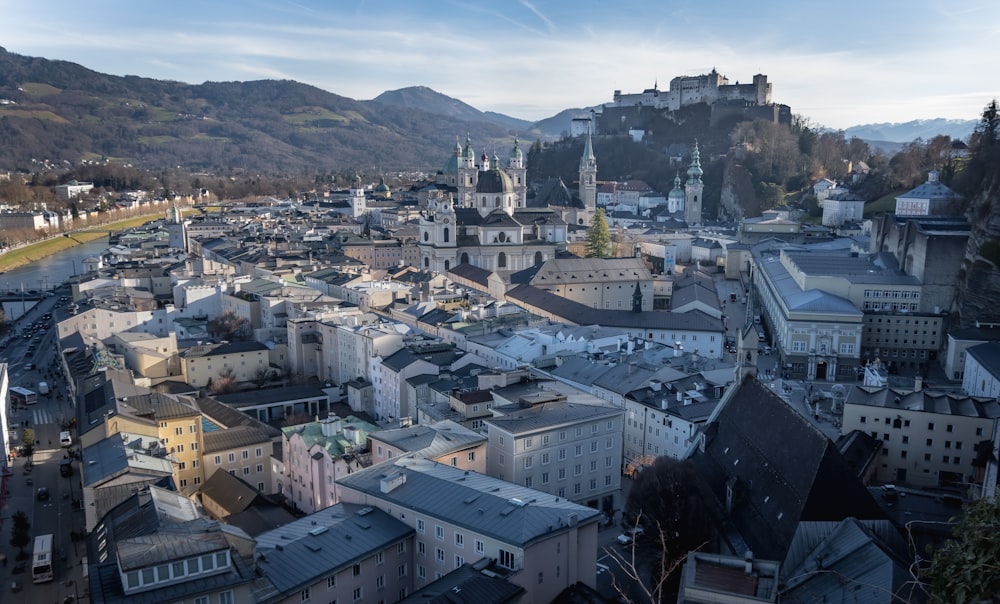 an aerial view of a city with mountains in the background