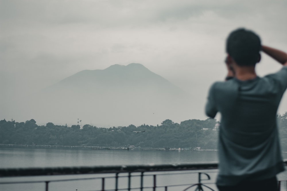 a man looking out over a body of water