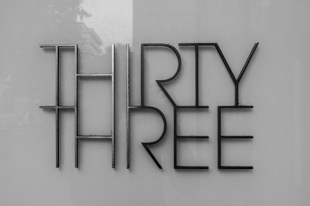 a black and white photo of a sign that says thirty three