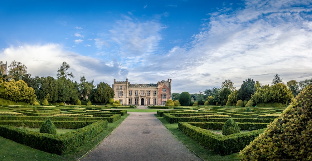 a large building sitting in the middle of a lush green park