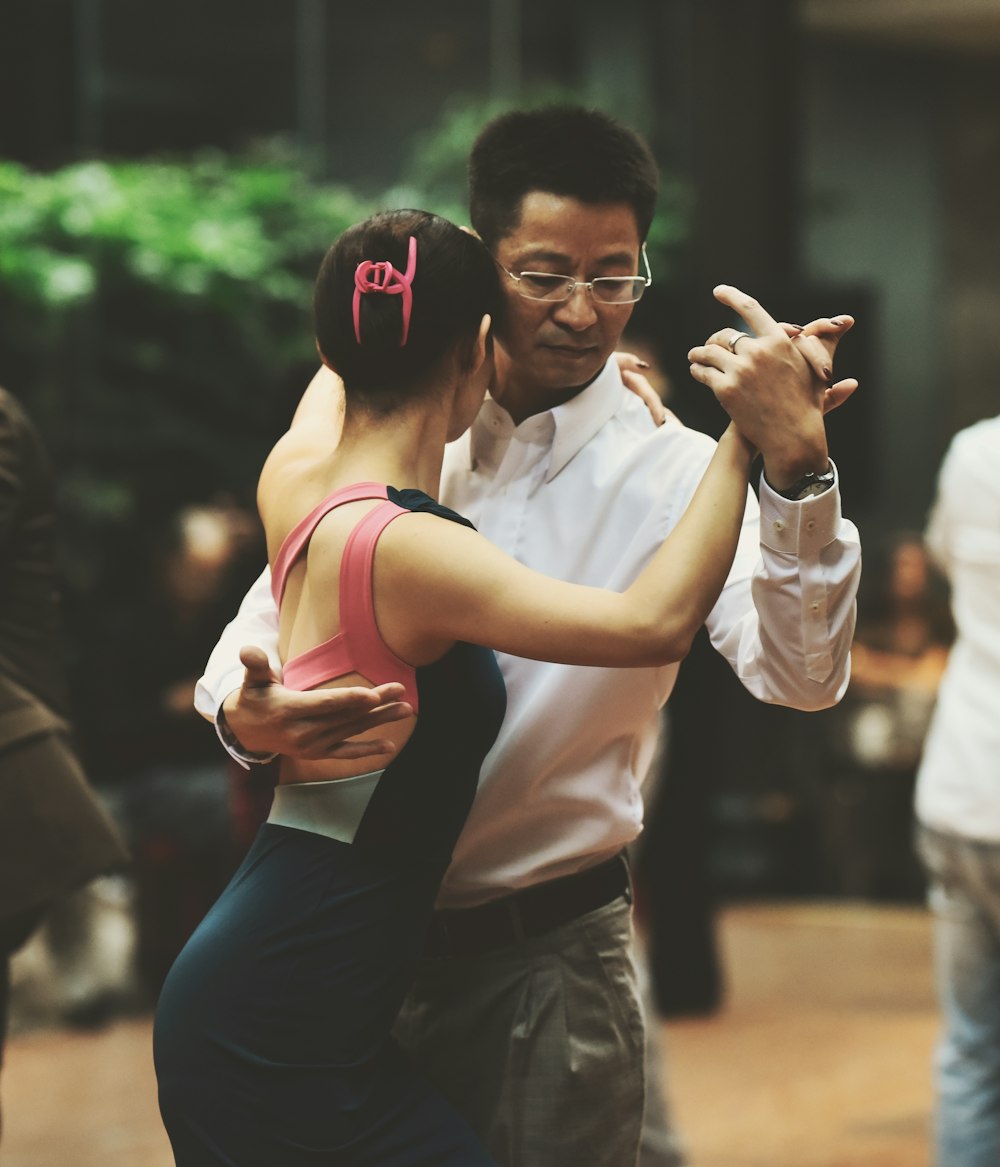 a man and a woman dance together in a ballroom