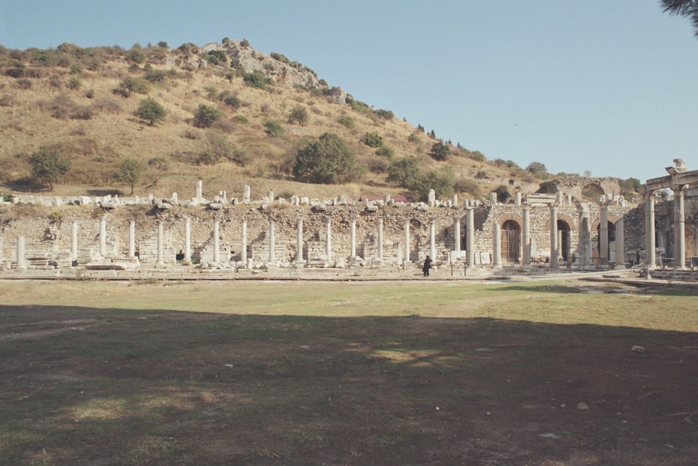 the ruins of a large building with a mountain in the background