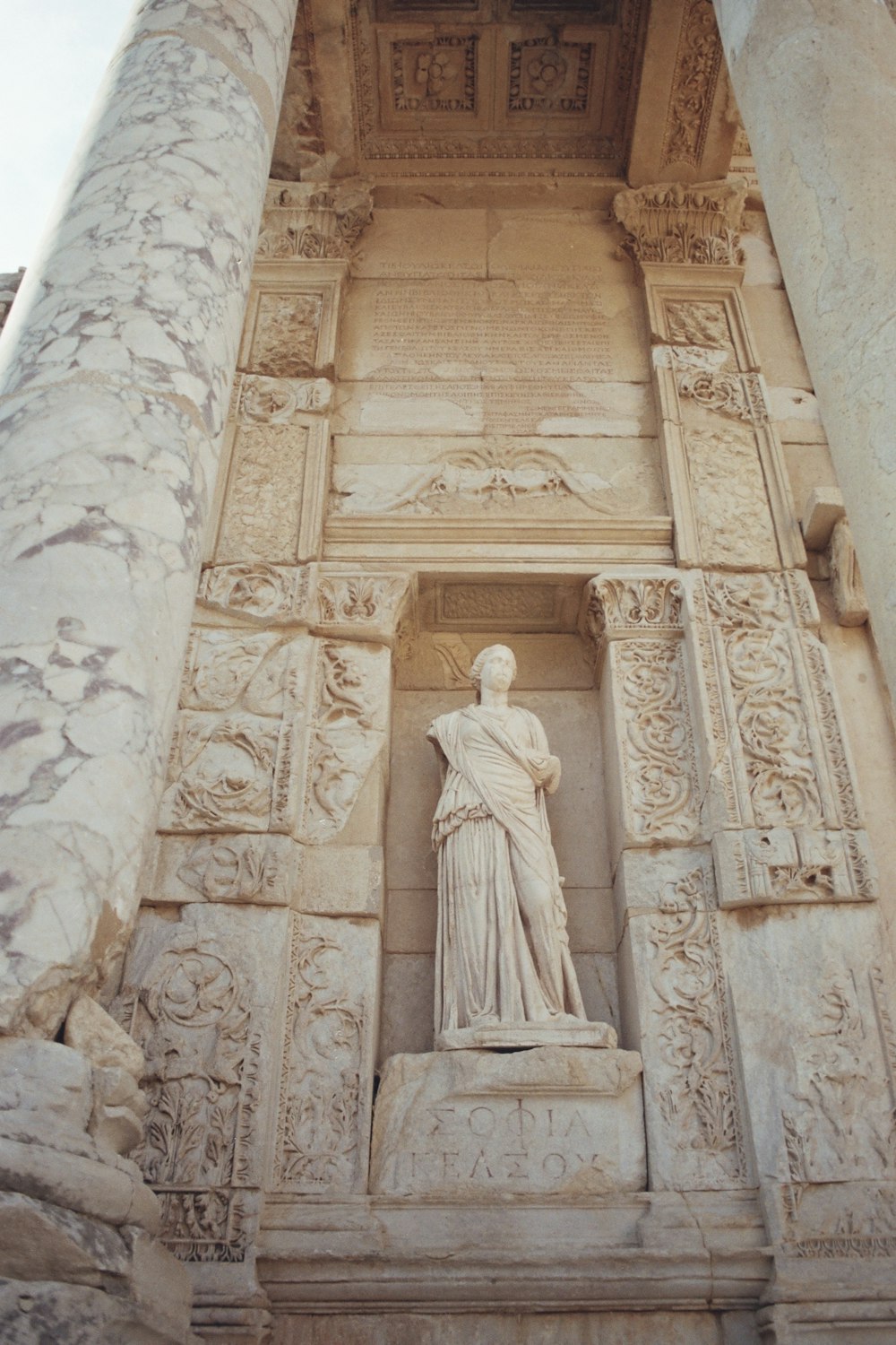 a statue of a woman is on the side of a building