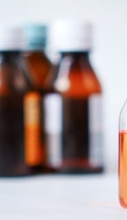 a bottle of liquid sitting on top of a table