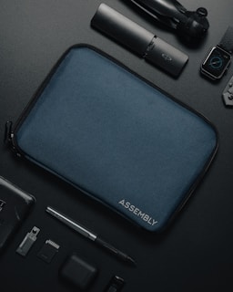 an assortment of electronics and accessories laid out on a table