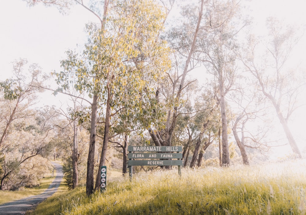 a sign on the side of a dirt road