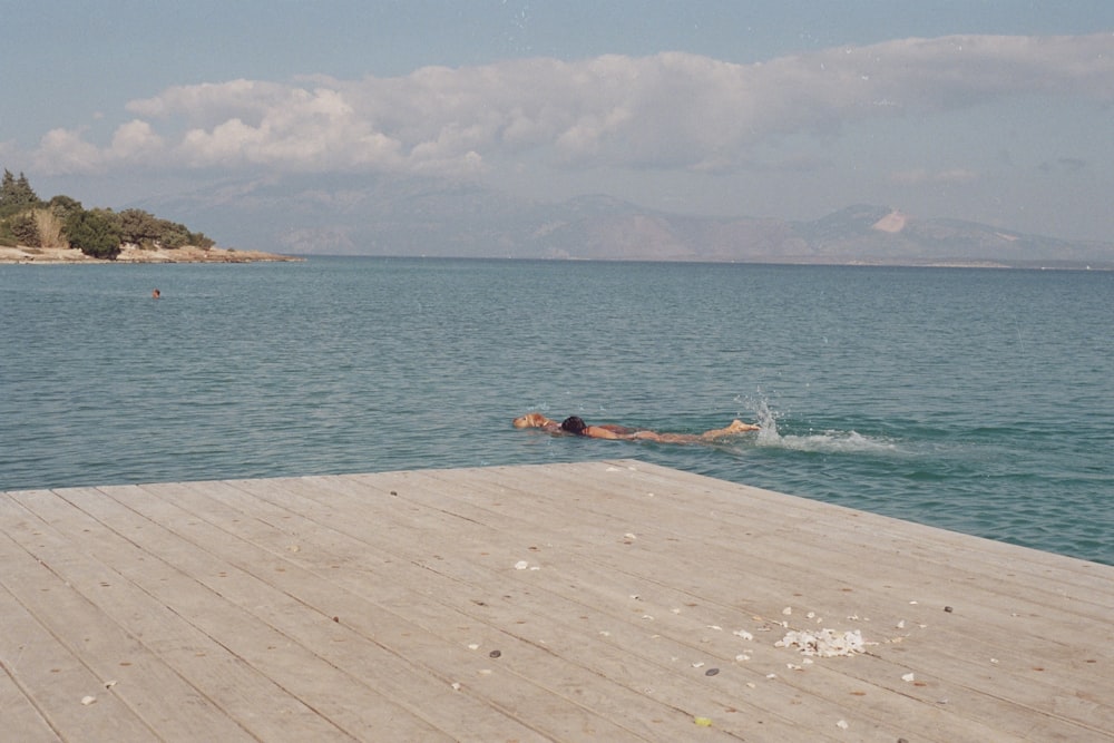 a person swimming in a body of water