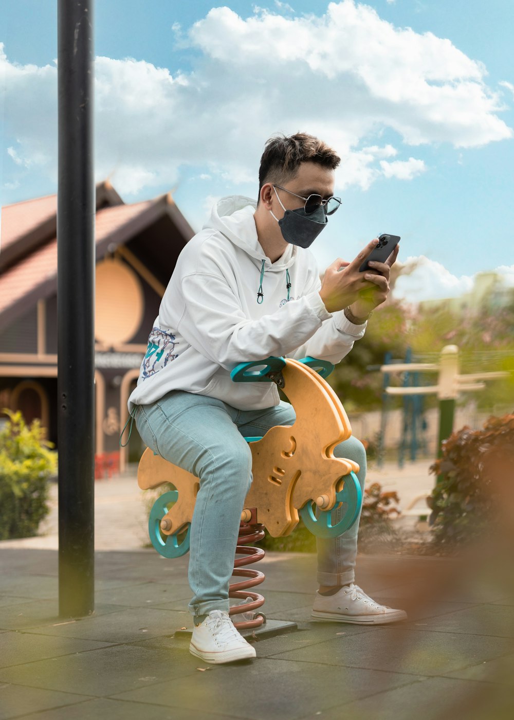 a man sitting on a bench using a cell phone