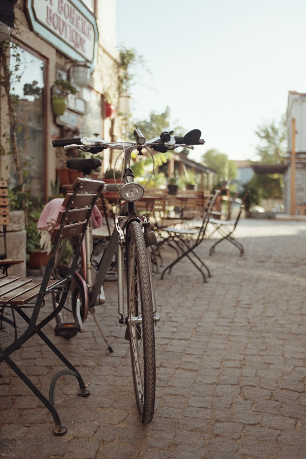 a bicycle parked next to a wooden bench