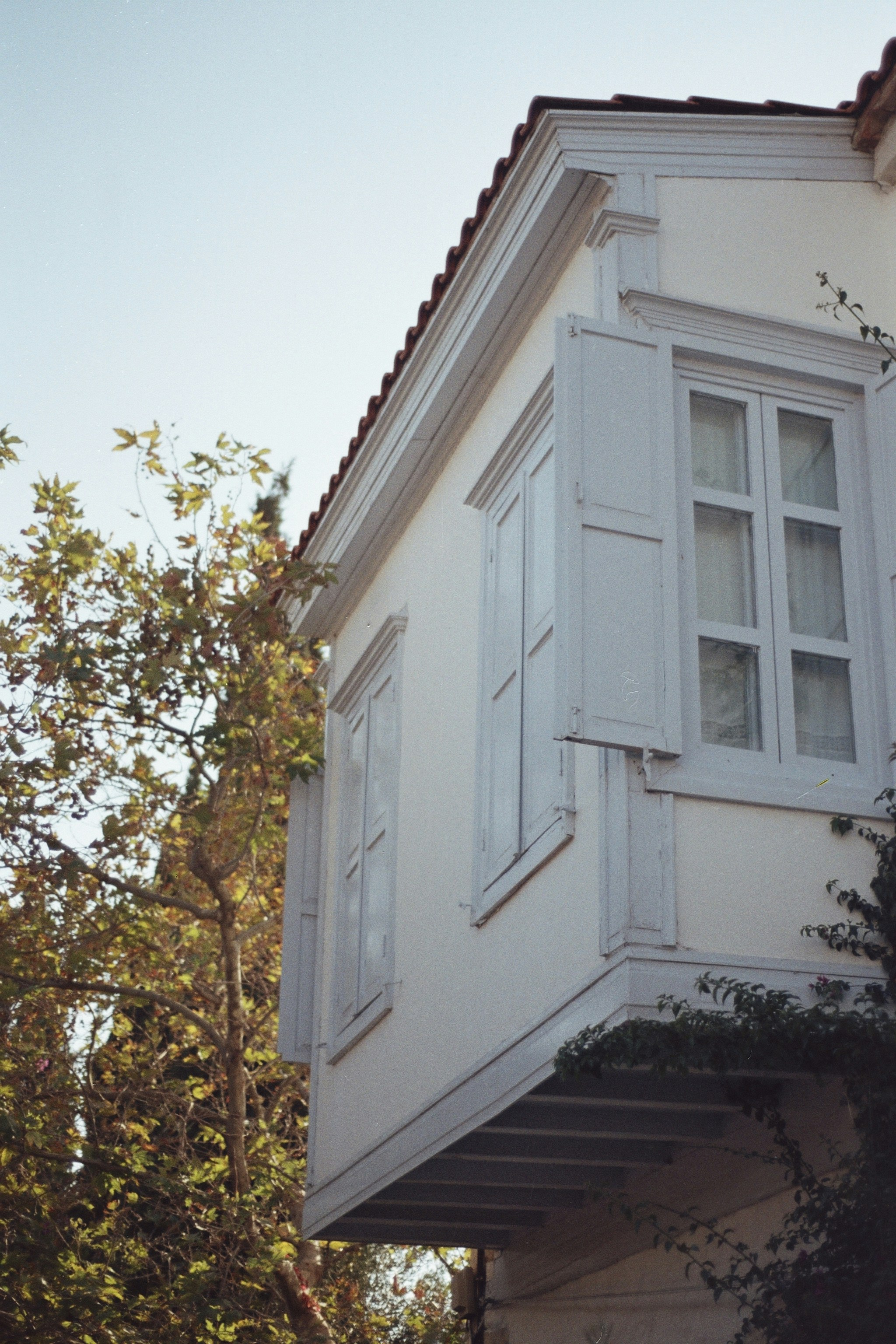 a tall white building with a clock on the side of it