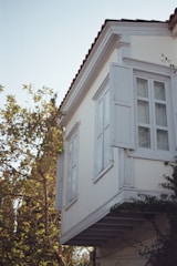a tall white building with a clock on the side of it