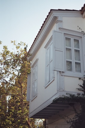a tall white building with a clock on the side of it