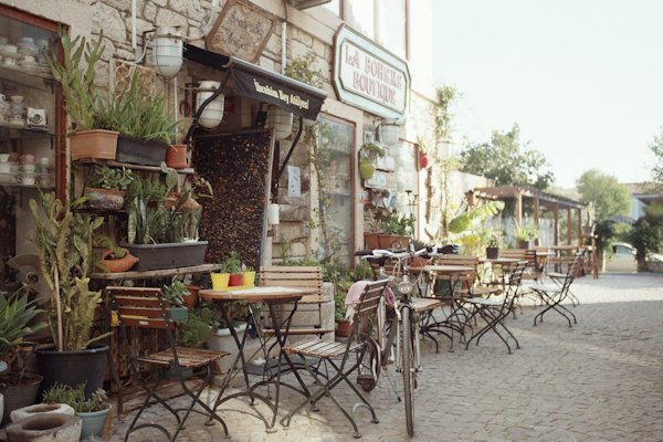A row of tables and chairs outside of a store — Çeşme & Alaçatı, Turkey