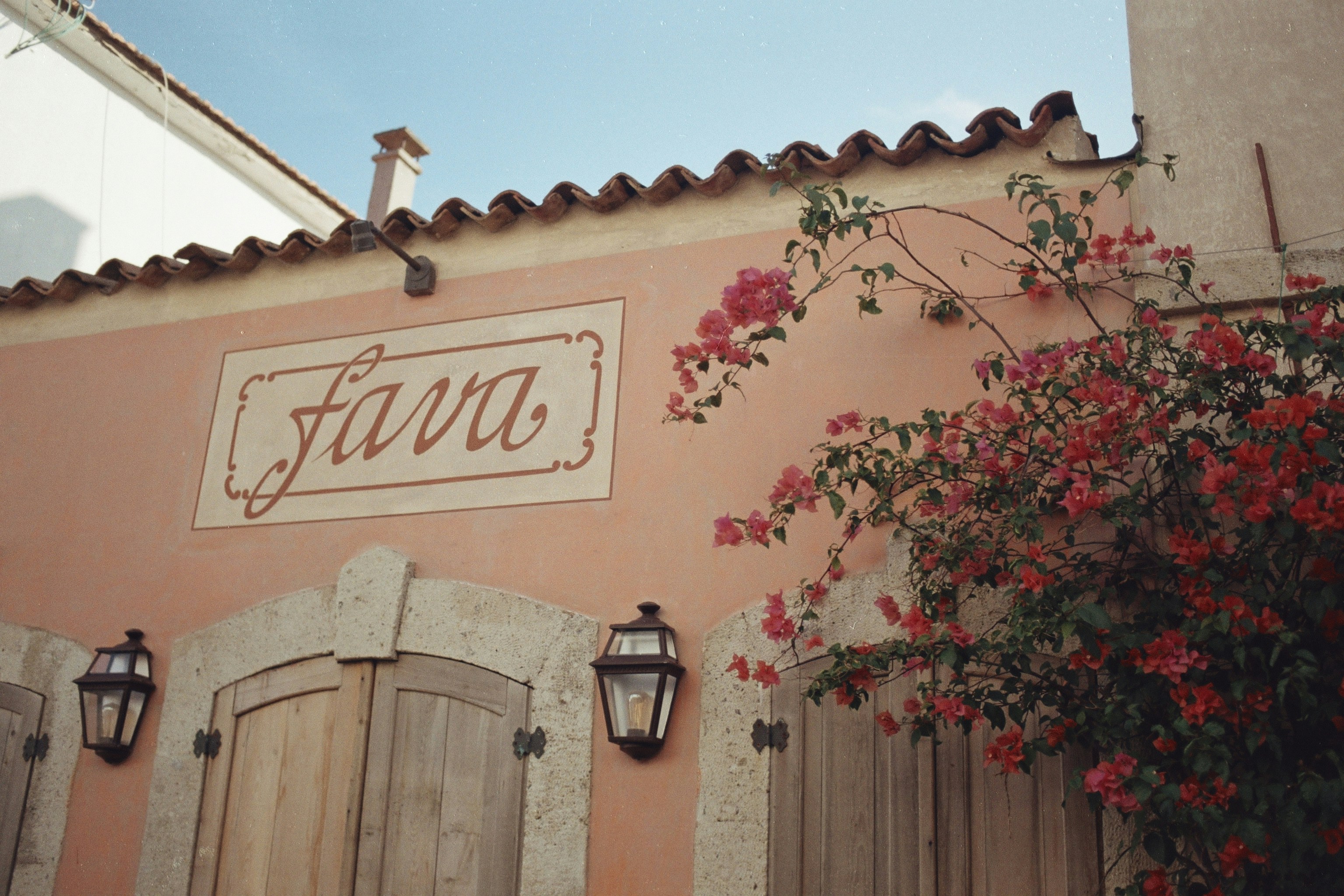 a pink building with a sign on the side of it