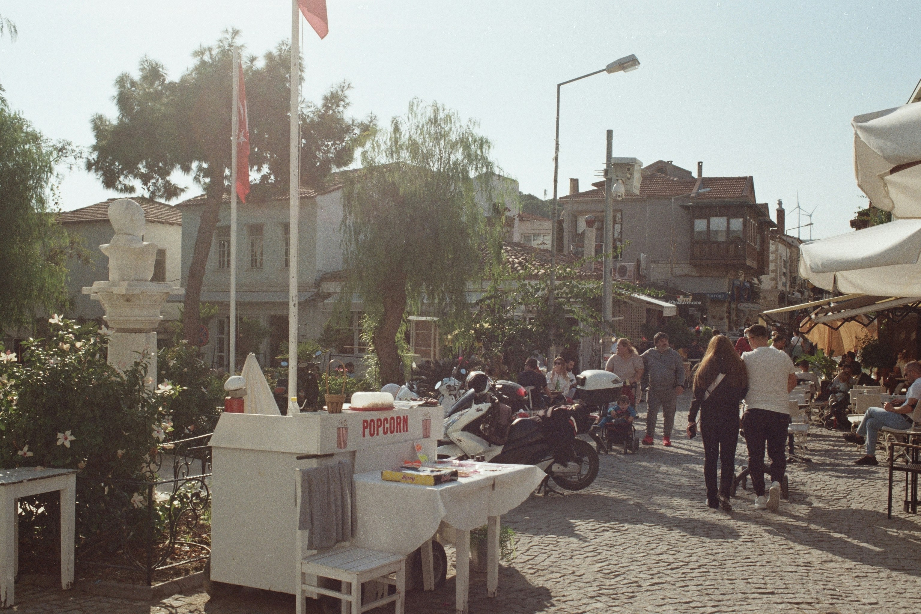 a group of people walking down a cobblestone street
