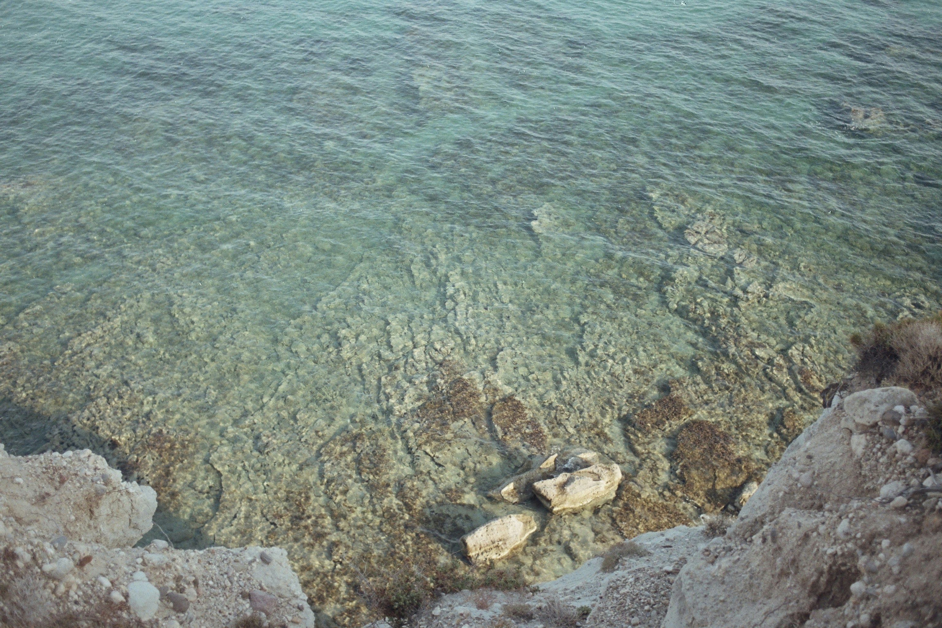 a body of water surrounded by rocks and water