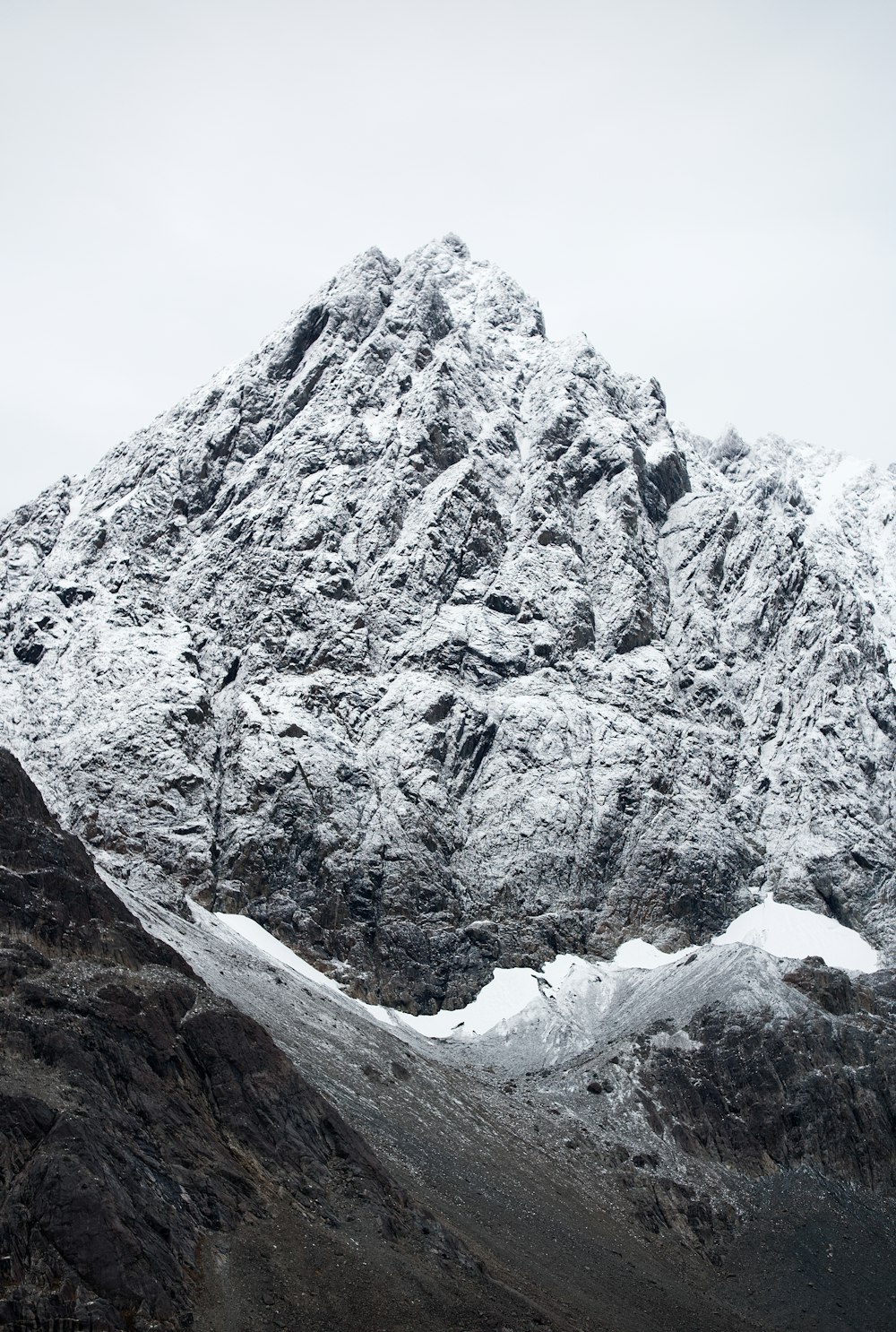 a mountain covered in snow on a cloudy day