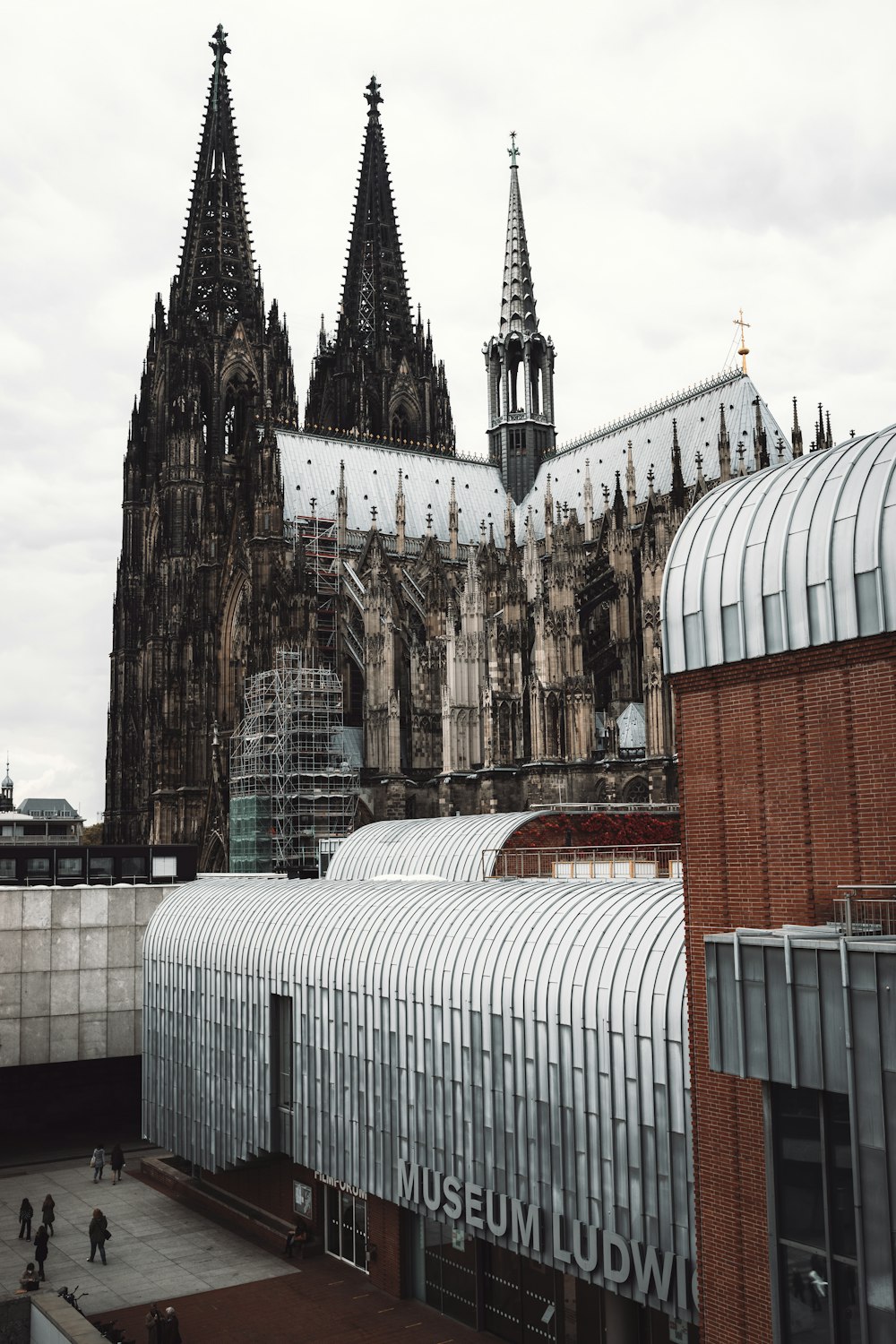 a large cathedral towering over a city filled with tall buildings