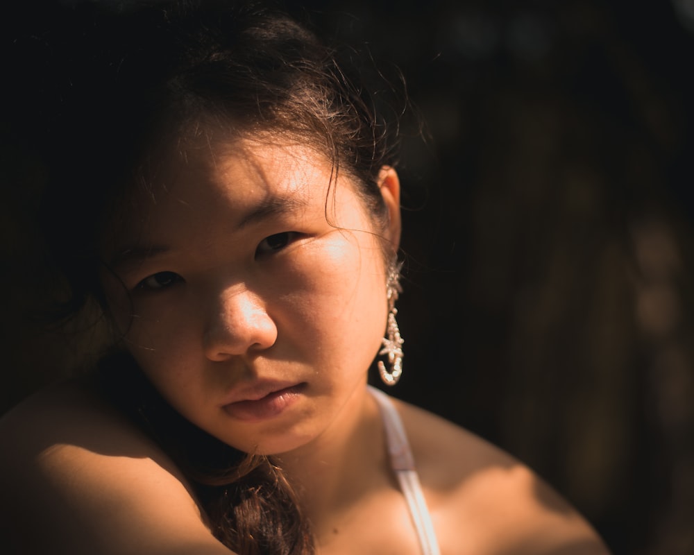 a woman in a white top is posing for a picture