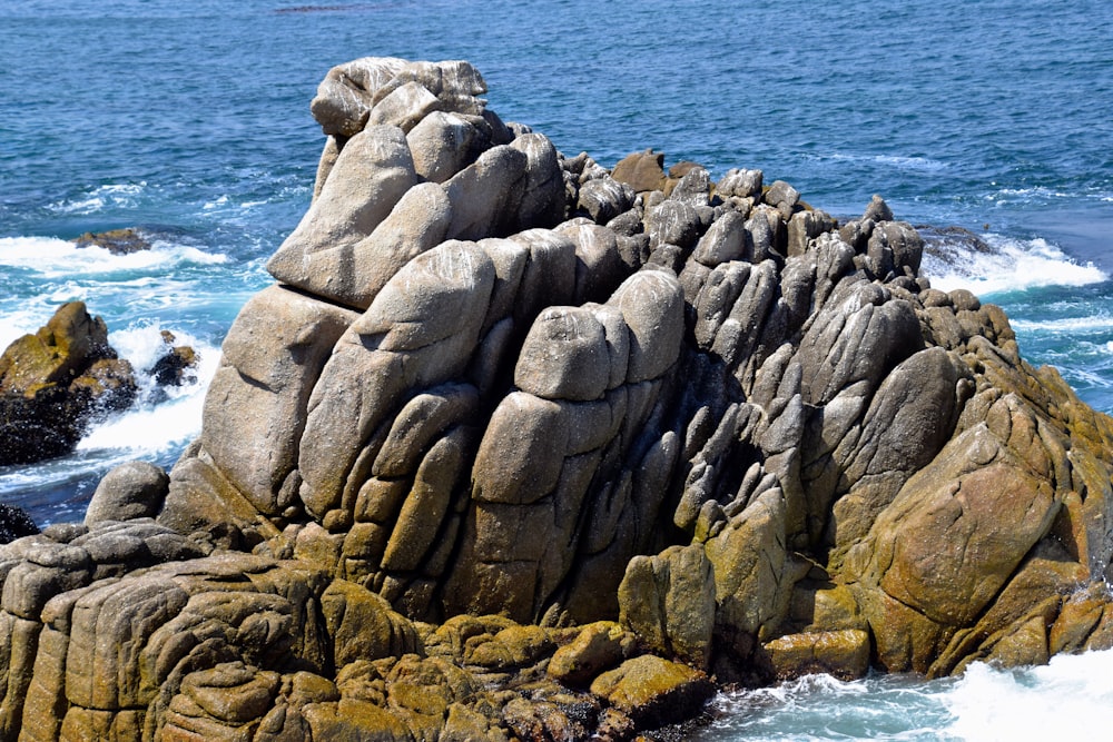 a large rock formation in the middle of the ocean