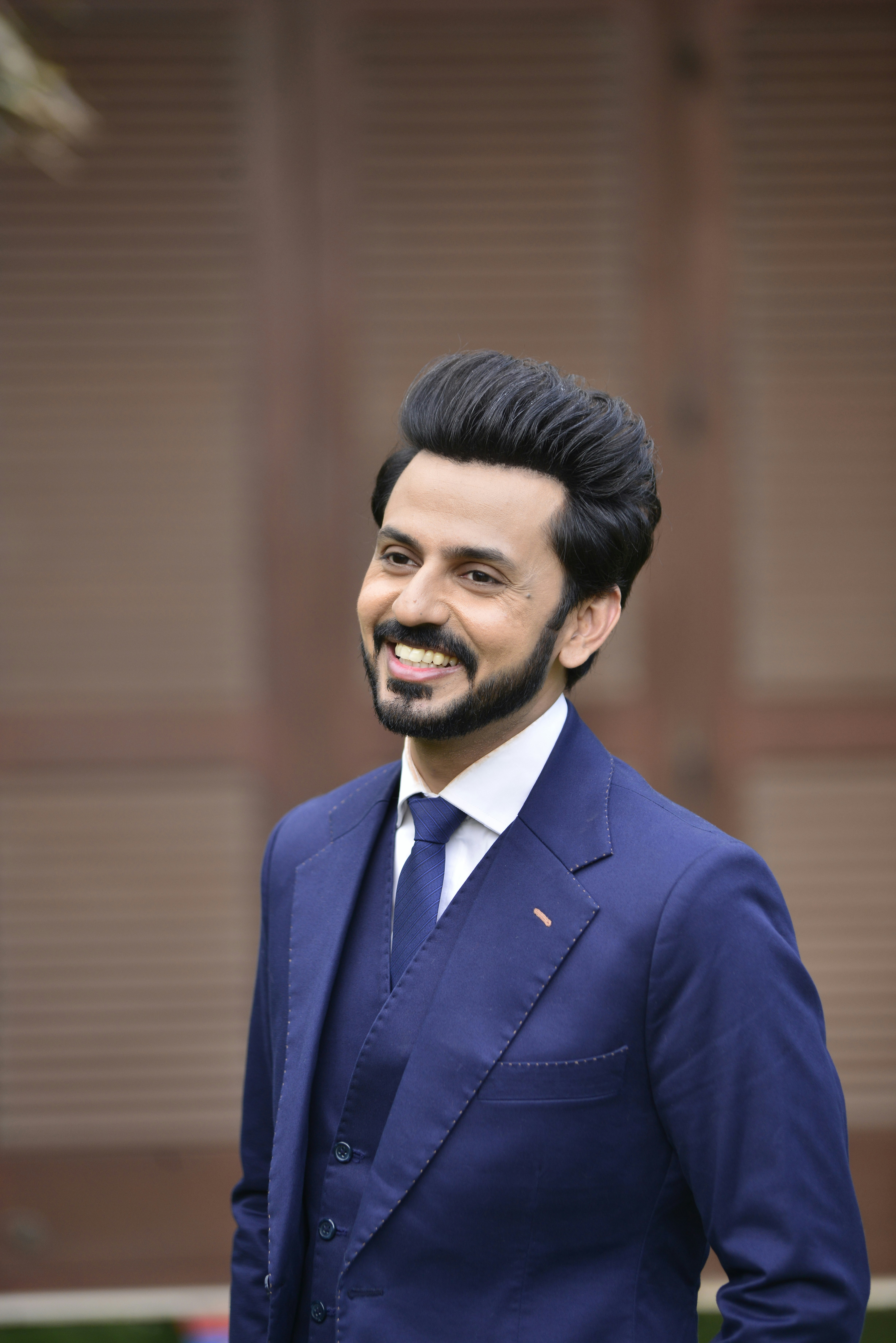 a man in a blue suit and tie