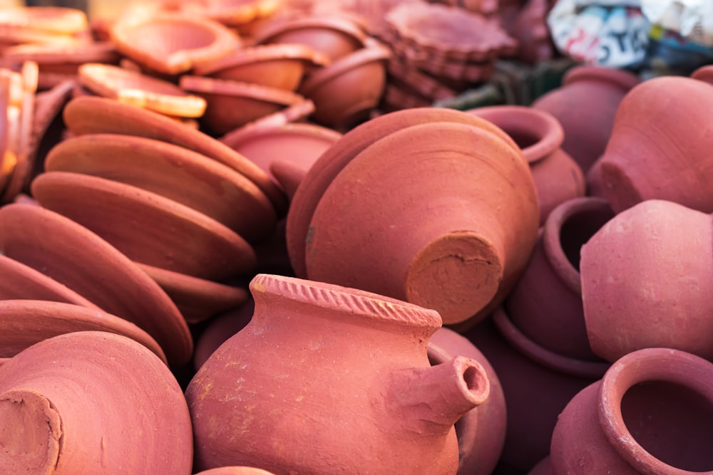 a pile of clay pots sitting next to each other
